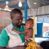 Concern's Early-Child Development Officer Mahamadou Boubakar helps healthcare staff at the Concern-supported intensive nutritional recovery centre (CRENI) at Tahoua Hospital carry out an initial assessment of 13-month-old Nana-Aicha who is severely malnourished. (Photo: Darren Vaughan/Concern Worldwide)