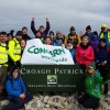 Group of climbers celebrate reaching top of Croagh Patrick