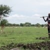 Farmer Nyabol Machar builds an embankment to protect her farmlands from oncoming floods in Unity State, South Sudan. (Photo: Jon Hozier-Byrne/Concern Worldwide)