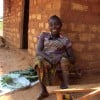 Tiyassi Joanette sits outside her home in Central African Republic on a sunny day