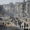 Displaced Palestinians start to return their houses past damaged buildings