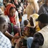 Concern Health and Nutrition Officer, Yamen Nassir, with Zarina* and baby Yaqub* at Ardamata Health Centre in West Darfur, Sudan. Yaqub* is severely acutely malnourished and has additional health complications. Photo: Kieran McConville/Concern Worldwide