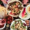  Dinner part scene shown from above. People share Palestinian food. 