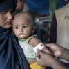 Ayesha*'s malnourished child Anwar* is measured by a Concern health worker in the nutrition center at Camp 13, Cox's Bazar. (Photo: Saikat Mojumder/Concern Worldwide)