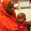 Amburo* (28) holds her youngest child Abshir*. Amburo is a mother of four children from Baidoa, now living in a displacement camp in Daynile District, Mogadishu. Photo: Adnan Mohamed/Concern Worldwide