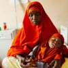 Halima* (40) and her baby Shukri* attend their local health centre. Halima* lives in Igadabagey IDP site in Marka with her five children (3 boys and 2 girls). Halima* was a farmer in Lower Shabelle area but Halima* and her family were displaced after the drought and moved to the IDP site in 2022. Photo: Adnan Mohamed/Concern Worldwide