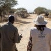 Concern staff member and representative from Irish Embassy to Sudan walk down a sandy road in Sira, Chad