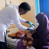 Doctor Muhammad Dek Jama treats Najma* (29) and her baby Cabdi* (18 months) at Banadir Hospital's Stabilisation Centre, Mogadishu. Photo: Hugh Golden/Concern Worldwide