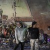 People stand at the site of a collapsed building following an earthquake in Caracas on June 25, 2026
