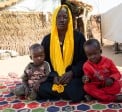 Nayla* (20) with her two sons, Ahmad* (2) and Ibrahim* (4) in red, in Chad