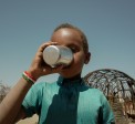 Muhktar drinks from a cup of water