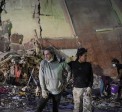 People stand at the site of a collapsed building following an earthquake in Caracas on June 25, 2026