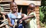 Sisters Esther and Jane Nyirenda hold one of their goats. Photo: Jennifer Nolan / Concern Worldwide.