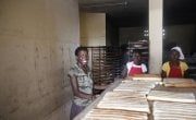 Christela Louis inside the bakery (supported by Concern) where she has worked since May. Christela is confident that through working here, she will be able to grow her business and start saving money. Photo: Kristin Myers /Concern Worldwide.