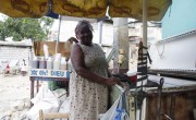 Alianna Antoine, one of the beneficiaries of the homes being built by Concern Worldwide. She works as a vendor, selling beverages at a stand in Grande Ravine. Photo: Kristin Myers / Concern Worldwide.