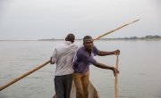 Fishermen in Kouango, CAR, steer a dugout canoe, which is often used to access remote river communities on the banks of the Oubangui, which seperates CAR and Democratic Republic of Congo (DRC). Photo: Kieran McConville / Concern Worldwide.