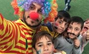 Concern staff member, Abdulrahman Rima, in a clown costume with Syrian children during Global Water Day in a playground in North Lebanon. Photo: AbdulRahman Rima / Concern Worldwide