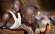 Tieni Gal (8) with her cousin Malech Jal (16) inside their home in Bentiu's PoC. Photo: Steve De Neef/Concern Worldwide.