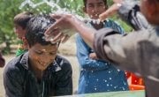 Somro and Kishore from Satla Bheel village playing with water at the newly installed plant system. Photo: Black Box Sounds/ Concern Worldwide.