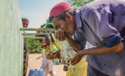 Local men from Satla Bheel village drink clean water from a water plant. Photo: Black Box Sounds / Concern Worldwide.