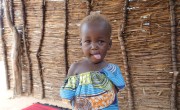 Khamissa Ibrahim is 32 years old mother of six. Pictured is little Rafaida (1). Khamissa is a Concern-trained Community Health Volunteer. She also sells onions, salt, garlic, oil, okra and chili. Concern’s support has greatly benefited Doroti village as there are less child and adult illnesses. There is a lower rate of malnutrition in women and children. Photo: Lucy Bloxham / Concern Worldwide.