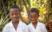 Brothers Darry (9) and Sala (7) from Toe Town, Liberia. Pictured here in their school shirts. These brothers benefit from a new water pump constructed by Concern Worldwide. Photo: Gavin Douglas / Concern Worldwide.