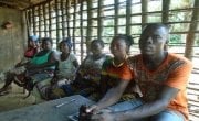 Soloman Tarr, sitting on the right alongside other members of the Gueh Town CSLA. Photo: Sam Holder / Concern Worldwide.