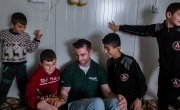 Michael Darragh Macauley meets with children living at an Iraq refugee camp.