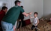 Michael Darragh Macauley meets with children living at an Iraq refugee camp. 