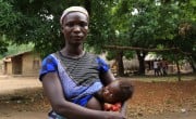 Rokoh Kargbo breastfeeding her baby during a COVID-19 information session.
