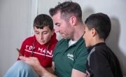 Dublin footballer Michael Darragh Macauley with two Syrian boys in Iraq where he visisted refugees being helped by Concern Worldwide in November 2019. Photo by Gavin Douglas of Concern Worldwide