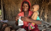 Subbi gives her daughter Wazeeran emergency therapeutic food.