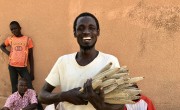 37-year-old Mika Abdu proudly displays some of his short-season millet crop, grown from seeds supplied by Concern.