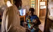 A young mother brings her baby to receive treatment for malnutrition in a health centre in DRC.