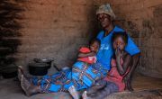 Caustasie and her granchildren sitting on floor in DRC