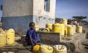 Young girl with containers of water 