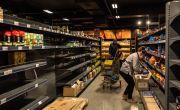 Supermarket staff stocking empty shelves