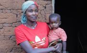 Care Group Volunteer holding her child in Burundi