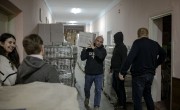 Illya* a person who has been displaced by conflict in Ukraine now volunteers at a community hub. Here, he is moving food kits as they are prepared for distribution. Photo: Simona Supino