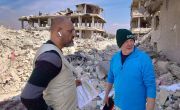 Emergency response staff consult each other amidst the rubble in Northern Syria.