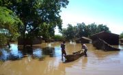 Two people with canoe in floodwater following Cyclone Freddy in Malawi