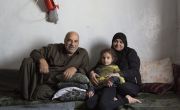 A Syrian family sitting on a floor