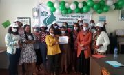 Female Concern staff in Ethiopia office gather under green and white balloons
