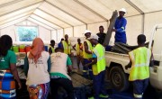 Concern staff in hi-vis jackets unloading truck with supplies