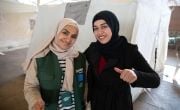 Concern staff member Leyma gives thumbs up with Syrian woman Ileaf in tent in Turkiye