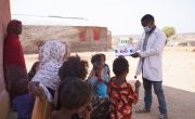 Group of women and children in Ethiopia receive nutrition education outside health centre