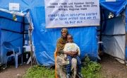 Woman and her son sitting outside mobile health clinic in Ethiopia