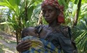 Woman holding her sleeping child in shawl in Burundi