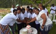 Concern Rwanda light candles on cake to celebrate International Women's Day