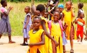 Children in school uniforms playing in playground in Sierra Leone